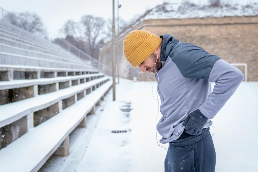 A man preparing to jog in the snow