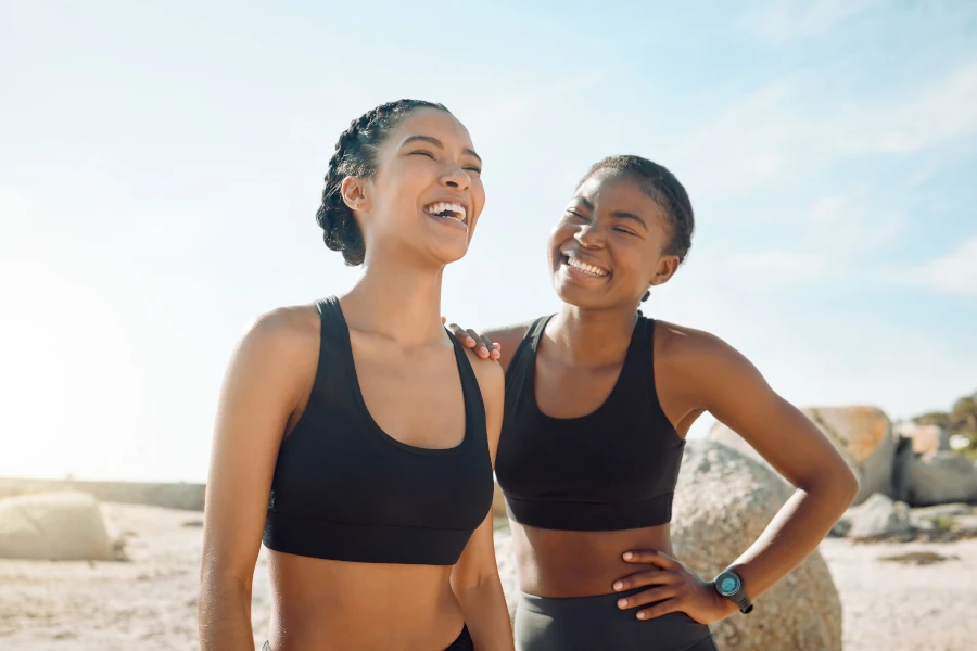 Two women smiling on a beach